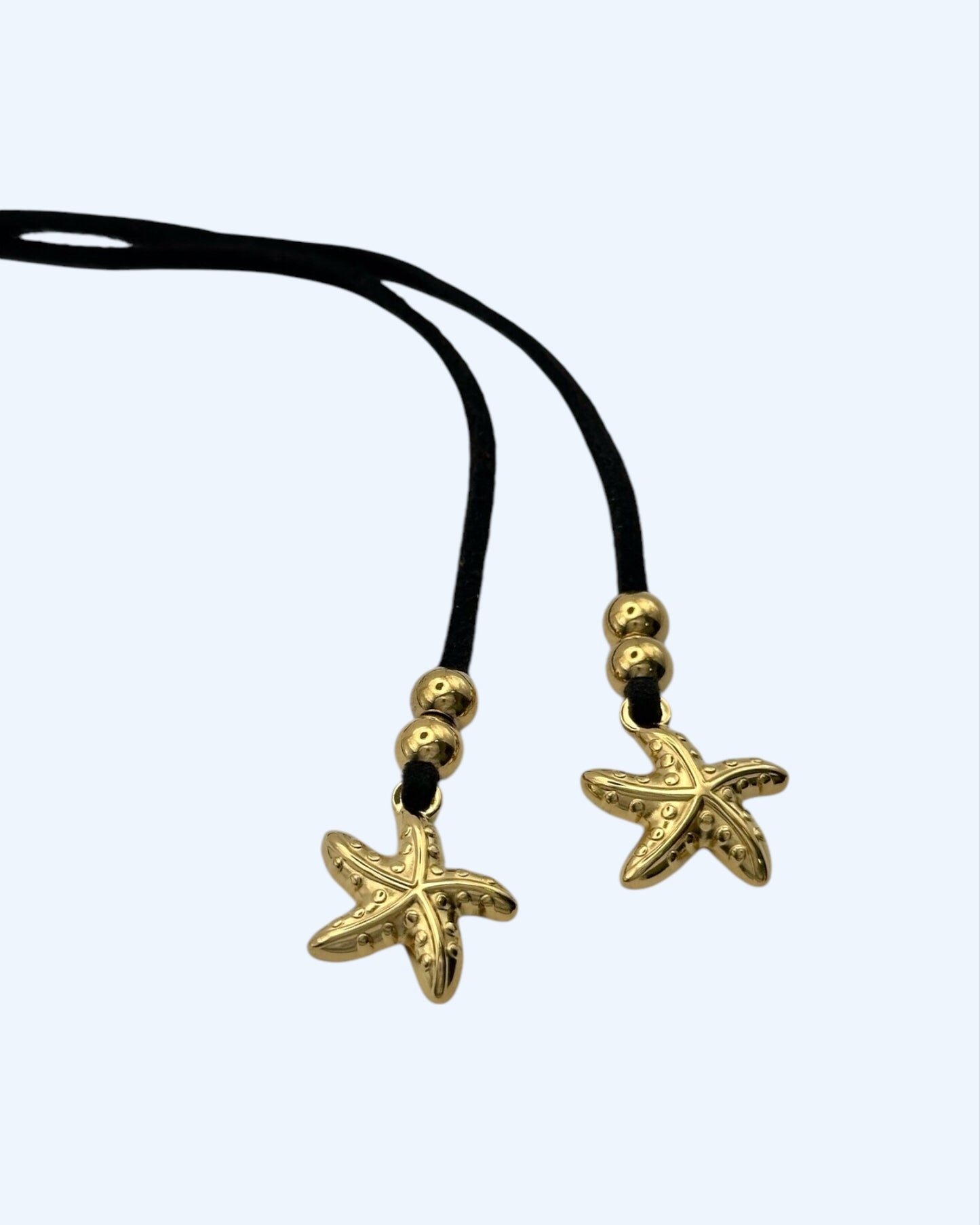 COLAR DE CAMURÇA COM ESTRELAS DO MAR em aço inoxidável