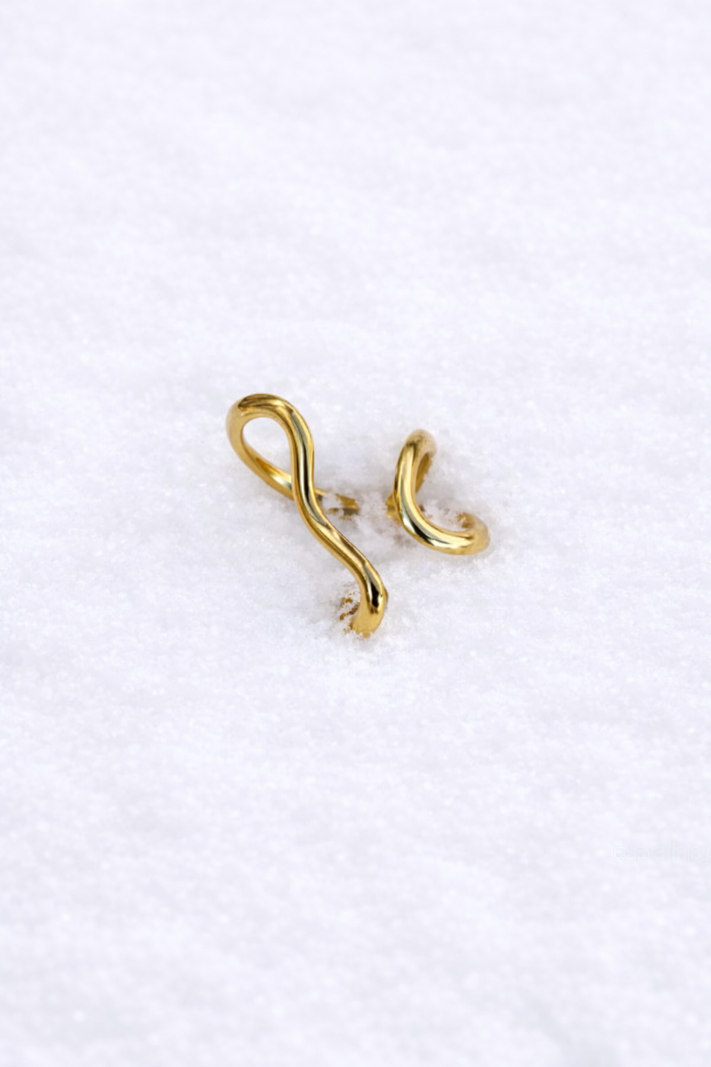 GOLDEN RING WITH CURVED CUT-OUTS IN STAINLESS STEEL
