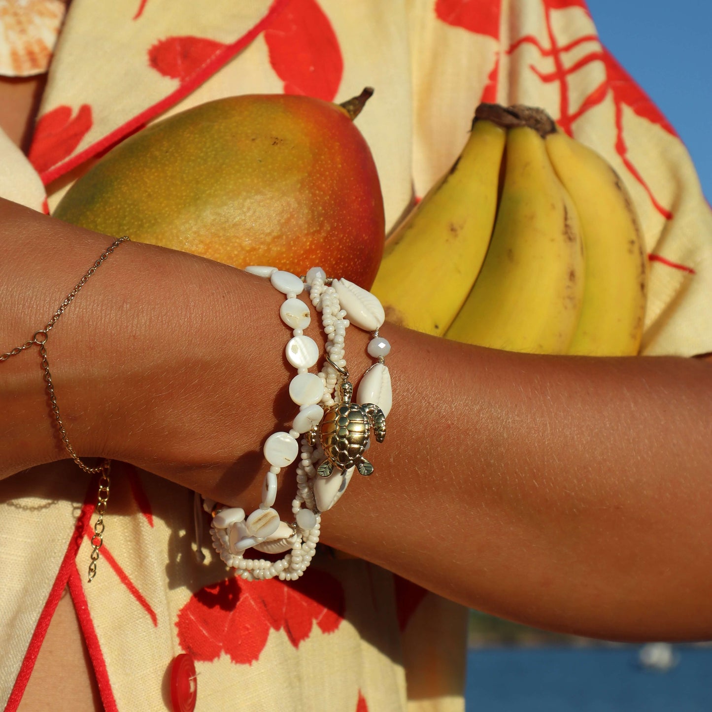 STEEL WRAP BRACELET WITH COWRIE SHELLS AND TURTLE
