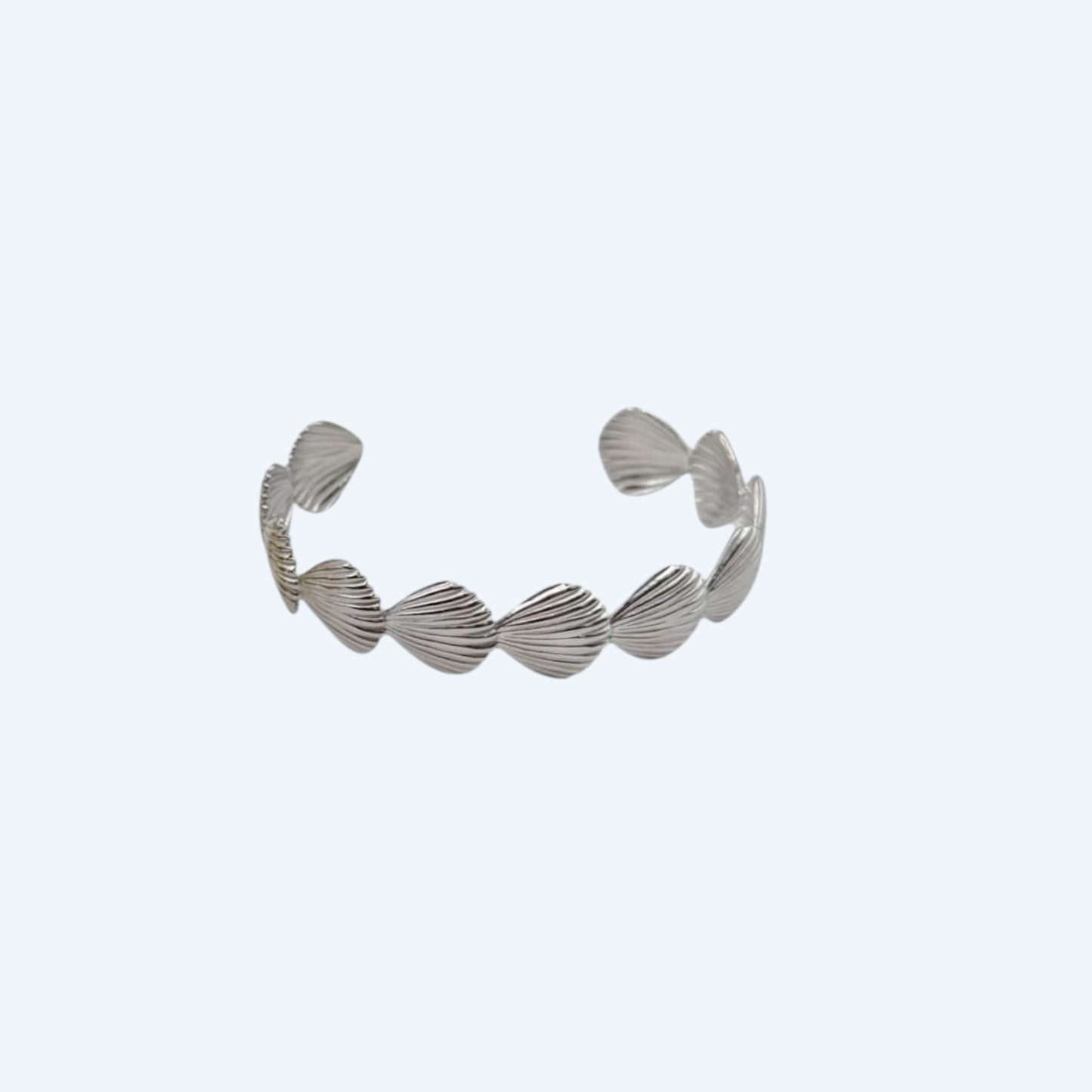 Vista frontal da Pulseira prateada com conchas em aço inoxidável de bracelete ajustável. Com vibe beach girl, esta pulseira é um detalhe do oceano para ser usado todos os dias ou em festas e festivais.