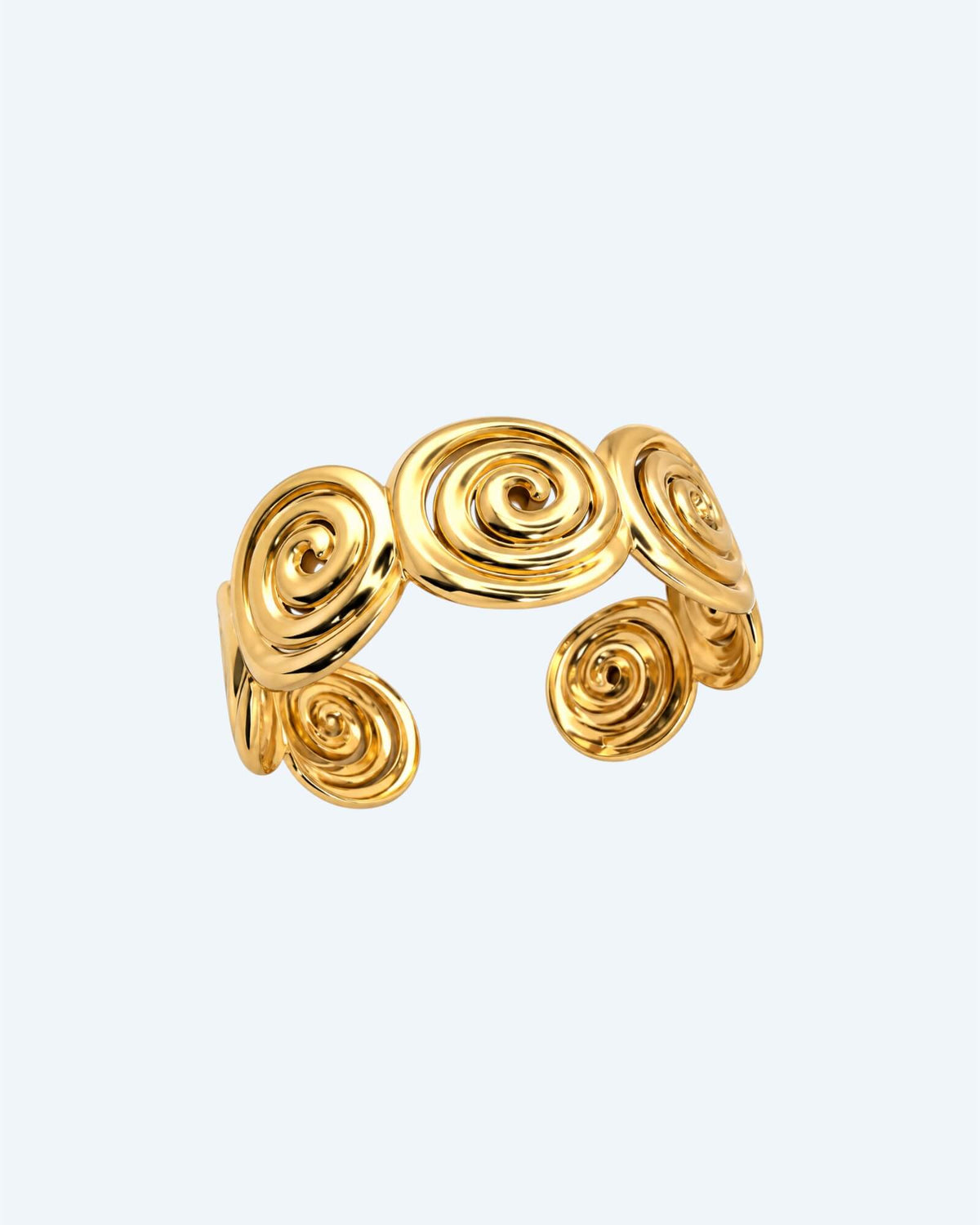 Vista de cima da Pulseira dourada rígida mas ajustável em aço inoxidável, composta por espirais recortadas e acabamento polido. Esta pulseira é ideal para looks boho ou urbanos, também para mais artisticos e de quem pretende ser simples com um detalhe ou para quem pretende juntar a um estilo bold. 